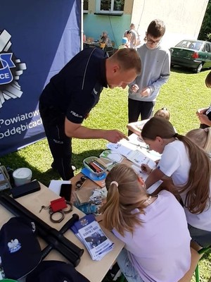 Policjant rozmawiający z dziećmi.